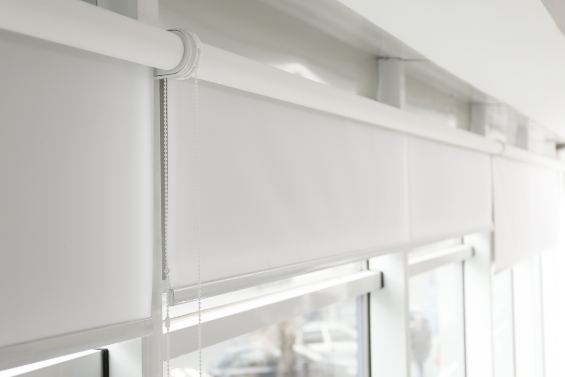Modern Window with White Roller Blinds Indoors